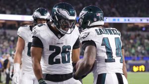 Philadelphia Eagles running back Kenneth Gainwell (14) is congratulated by running back Saquon Barkley (26) after scoring against the Los Angeles Rams during the second half of an NFL football game. (Ryan Sun/AP)