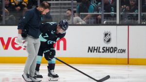 Seattle Kraken right wing Jordan Eberle leaves the ice with head athletic trainer Justin Rogers after colliding with the boards during the second period of an NHL hockey game against the Chicago Blackhawks, Thursday, Nov. 14, 2024, in Seattle. (Lindsey Wasson/AP)