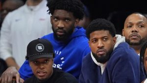 From left, Philadelphia 76ers' Joel Embiid, Kyle Lowry and Paul George watch from the bench during the second half of an NBA basketball game, Sunday, Nov. 24, 2024, in Philadelphia. (Matt Slocum/AP)