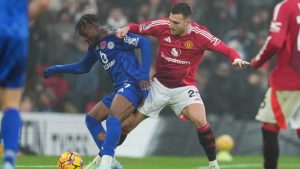 Manchester United's Diogo Dalot challenges for the ball with Leicester's Abdul Fatawu during the English Premier League soccer match between Manchester United and Leicester City, at the Old Trafford stadium in Manchester, England, Sunday, Nov. 10, 2024. (Jon Super/AP)