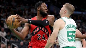 Toronto Raptors center Bruno Fernando (24) defends the ball from Boston Celtics forward Baylor Scheierman (55) during the first half of a preseason NBA basketball game, Sunday, Oct. 13, 2024, in Boston. (Mark Stockwell/AP)