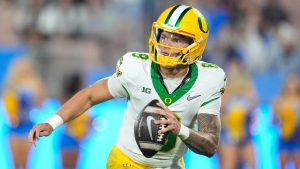 Oregon quarterback Dillon Gabriel (8) rolls out during the second half of an NCAA college football game against UCLA Saturday, Sept. 28, 2024, in Pasadena, Calif. (Marcio Jose Sanchez/AP Photo)