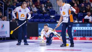 Brad Gushue (centre) flanked by sweepers Geoff Walker (left) and Brendan Bottcher (right) in action during the KIOTI National on Nov. 26, 2024, in St. John's, N.L. (Anil Mungal/GSOC)