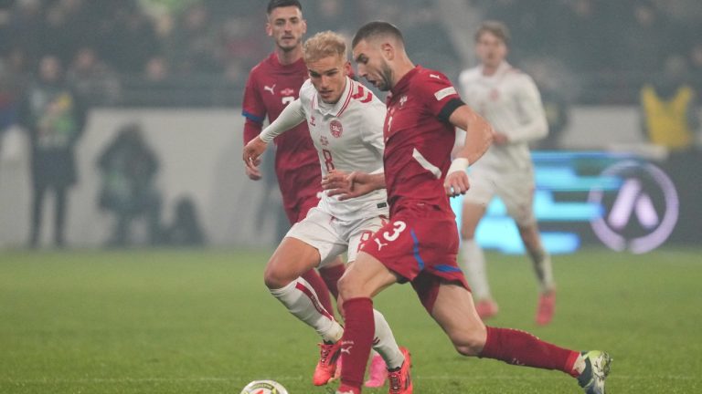 Denmark's Gustav Isaksen, left, and Serbia's Strahinja Pavlovic fight for the ball during the UEFA Nations League soccer match between Serbia and Denmark at the Dubocica Stadium in Leskovac, Serbia, Monday, Nov. 18, 2024. (Darko Vojinovic/AP)