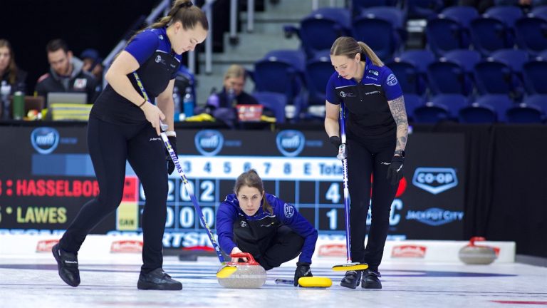 Anna Hasselborg (centre) shoots a stone as Agnes Knochenhauer (left) and Sofia Mabergs (right) prepare to sweep during the KIOTI National on Nov. 26, 2024, in St. John's, N.L. (Anil Mungal/GSOC)