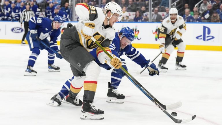 Vegas Golden Knights' Brett Howden (21) land Toronto Maple Leafs' Morgan Rielly (44) battle for the puck during third period NHL hockey action in Toronto, on Wednesday, November 20, 2024. (Chris Young/CP)