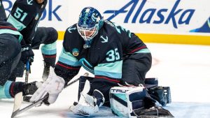 Seattle Kraken goalie Joey Daccord makes a glove save during the third period of an NHL hockey game against the Calgary Flames, Saturday, Oct. 19, 2024, in Seattle. (Stephen Brashear/AP)