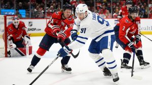 Toronto Maple Leafs centre John Tavares (91) skates with the puck past Washington Capitals defenseman Rasmus Sandin (38) and defenseman Matt Roy (3) during the second period of an NHL hockey game, Wednesday, Nov. 13, 2024, in Washington. (Nick Wass/AP)