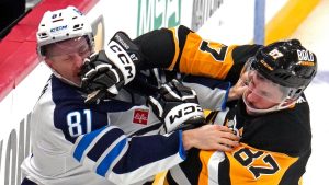 Pittsburgh Penguins' Sidney Crosby (87) fights with Winnipeg Jets' Kyle Connor (81) during the third period of an NHL hockey game Friday, Nov. 22, 2024, in Pittsburgh. The Jets won 4-1. (Gene J. Puskar/AP)