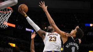 Los Angeles Lakers' LeBron James (23) goes to the basket against San Antonio Spurs' Victor Wembanyama during the first half of an Emirates NBA Cup basketball game, Friday, Nov. 15, 2024, in San Antonio. (AP Photo/Darren Abate)