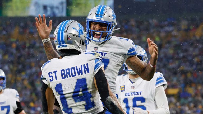 Detroit Lions wide receiver Amon-Ra St. Brown (14) reacts with Detroit Lions wide receiver Tim Patrick (17) after catching a touchdown against the Green Bay Packers during the first half of an NFL football game. (Jeffrey Phelps/AP)