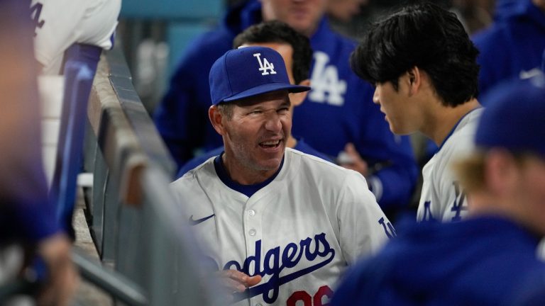 Los Angeles Dodgers first base coach Clayton McCullough (86) talks with designated hitter Shohei Ohtani, right, in the dugout during the sixth inning of a baseball game against the Miami Marlins in Los Angeles, Monday, May 6, 2024. (Ashley Landis/AP)