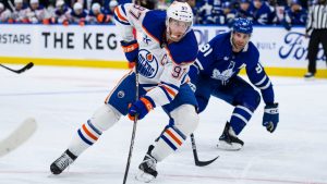 Edmonton Oilers centre Connor McDavid (97) attacks the net while defended by Toronto Maple Leafs centre John Tavares (91) during first period NHL hockey action, in Toronto, Saturday, Nov. 16, 2024. (Christopher Katsarov/CP)