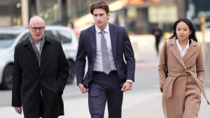 Michael McLeod, centre, a former team Canada World Junior hockey player arrives at court in London, Ont., Monday, Nov. 25, 2024. (Nathan Denette/CP)