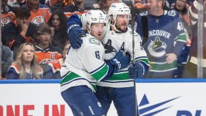 Vancouver Canucks' Brock Boeser (6) and J.T. Miller (9) celebrate a goal against the Edmonton Oilers during first period second-round NHL playoff action in Edmonton on Sunday May 12, 2024. (Jason Franson/CP)