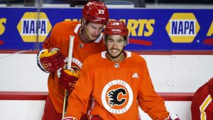 Calgary Flames' Johnny Gaudreau, right, and Sean Monahan chat during opening day of training camp in Calgary, Thursday, Sept. 23, 2021. (Jeff McIntosh/CP)