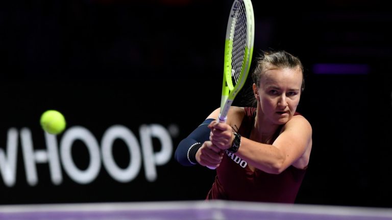 Czech Republic's Barbora Krejcikova, in action with China's Qinwen Zheng during women's singles semi final match at King Saud University Indoor Arena, in Riyadh, Saudi Arabia, Friday, Nov. 8, 2024. (AP Photo)