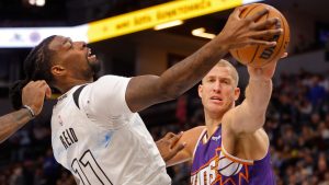 Phoenix Suns centre Mason Plumlee, right, challenges Minnesota Timberwolves centre Naz Reid (11) for the ball in the second quarter of an NBA basketball game Sunday, Nov. 17, 2024, in Minneapolis. (Bruce Kluckhohn/AP)