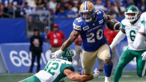 Winnipeg Blue Bombers' Brady Oliveira (20) runs for the first down against the Saskatchewan Roughriders during the first half of CFL Banjo Bowl action. (John Woods/CP)