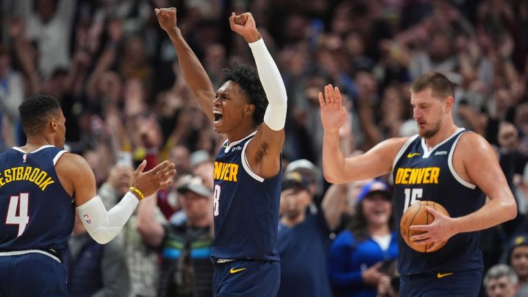 Denver Nuggets forward Peyton Watson, centre, celebrates with guard Russell Westbrook (4) and center Nikola Jokic after Dallas Mavericks guard Kyrie Irving missed a last-second shot as time ran out in the second half of an NBA basketball game Sunday, Nov. 10, 2024, in Denver. (David Zalubowski/AP)