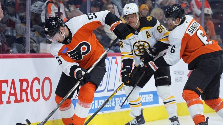 Philadelphia Flyers' Rasmus Ristolainen, left, tries to clear the puck past Boston Bruins' David Pastrnak, center, and Travis Sanheim during the first period of an NHL hockey game, Saturday, Nov. 2, 2024, in Philadelphia. (Matt Slocum/AP)