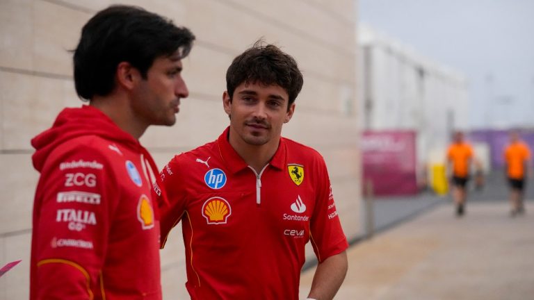 Ferrari driver Carlos Sainz of Spain, left, and Ferrari driver Charles Leclerc of Monaco walk through paddock at the Lusail International Circuit in Lusail, Qatar, ahead of the Qatar Grand Prix, Thursday, Nov. 28, 2024. (Darko Bandic/AP)