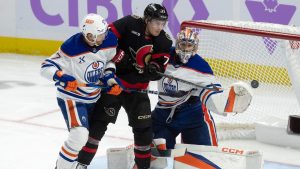 Ottawa Senators centre Ridly Greig (71) tries to tip the puck past Edmonton Oilers goaltender Stuart Skinner under pressure from Oilers' Brett Kulak (27) during second period NHL action, in Ottawa, Tuesday, Nov. 19, 2024. (Adrian Wyld/THE CANADIAN PRESS)