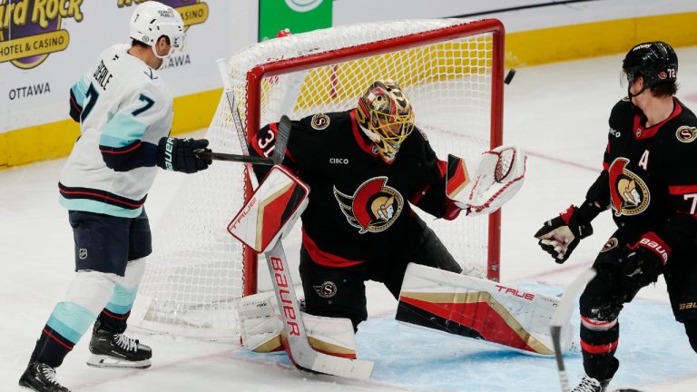 The puck goes off the post behind Ottawa Senators goaltender Anton Forsberg as Senators defenceman Thomas Chabot (right) and Seattle Kraken right wing Jordan Eberle look on during second period NHL action, Saturday, Nov. 2, 2024 in Ottawa. (Adrian Wyld/CP)