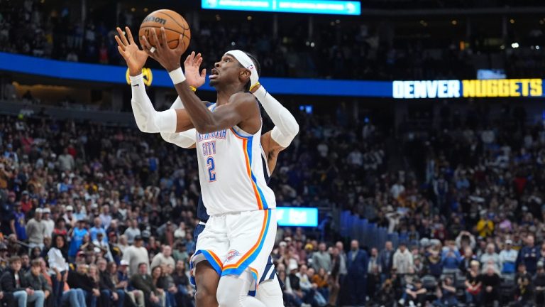 Oklahoma City Thunder guard Shai Gilgeous-Alexander, front, drives past Denver Nuggets guard Russell Westbrook to put up a last-second shot that was blocked by forward Peyton Watson as time ran out in an NBA basketball game Wednesday, Nov. 6, 2024, in Denver. (David Zalubowski/AP)