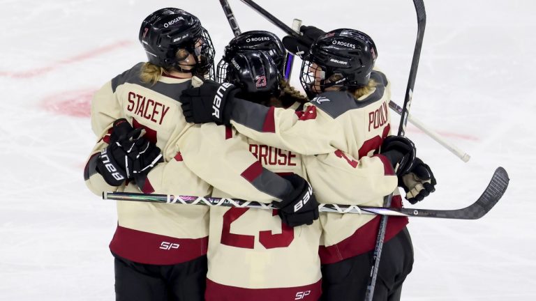 Montreal forward Laura Stacey, left, defender Erin Ambrose, centre, and forward Marie-Philip Poulin celebrate a goal by forward Maureen Murphy against Boston during the second period of a PWHL playoff hockey game Tuesday, May 14, 2024, in Lowell, Mass. (Mark Stockwell/AP)