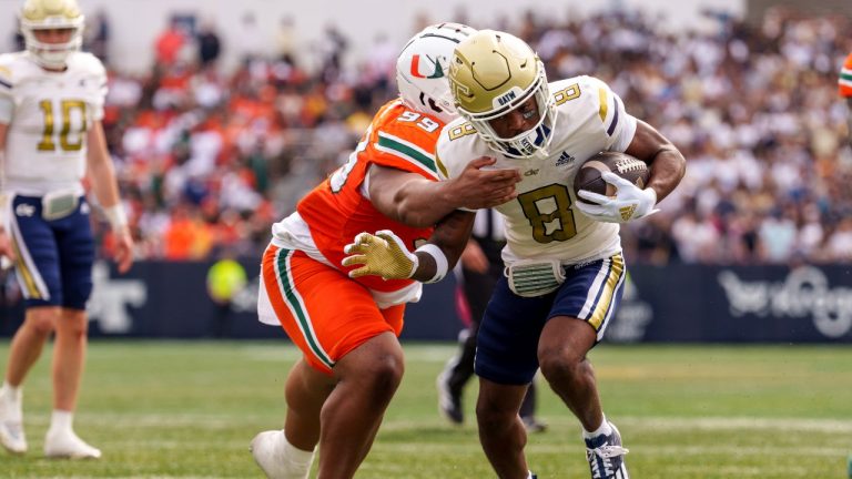 Miami defensive lineman Ahmad Moten Sr. (99) attempts to tackle Georgia Tech wide receiver Malik Rutherford (8) as he runs into the end zone during the first half of an NCAA college football game, Saturday, Nov. 9, 2024, in Atlanta. (Jason Allen/AP Photo)