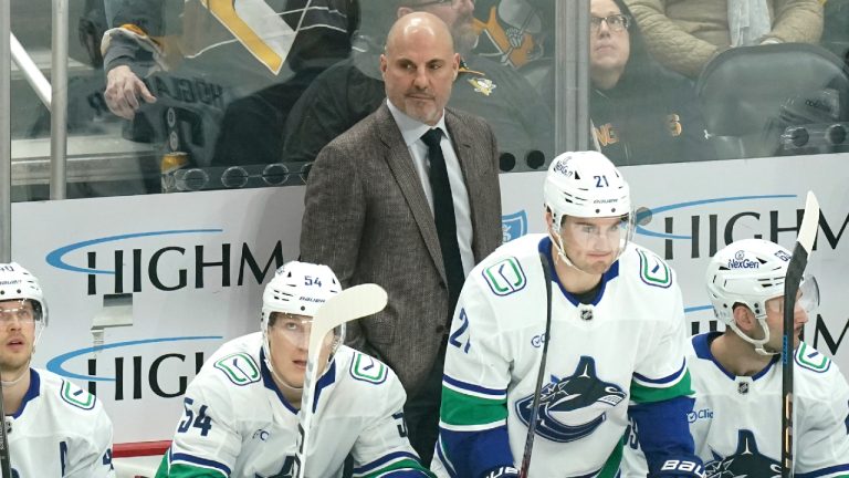 Vancouver Canucks head coach Rick Tocchet stands behind his bench during the first period of an NHL hockey game against the Pittsburgh Penguins Wednesday, Nov. 27, 2024, in Pittsburgh. (Matt Freed/AP)