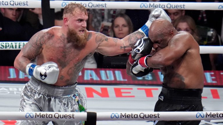 Jake Paul hits Mike Tyson during their heavyweight boxing match, Friday, Nov. 15, 2024, in Arlington, Texas. (Julio Cortez/AP Photo)