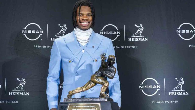 Heisman Trophy finalist Travis Hunter, of Colorado, stands with the trophy during a college football press conference, Saturday, Dec. 14, 2024, in New York. (Corey Sipkin/AP)