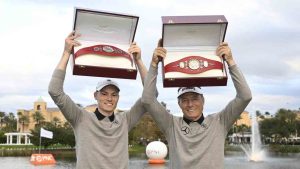 Bernhard Langer, right, and his son Jason Langer hold the championship belts after winning the PNC Championship golf tournament, Sunday, Dec. 22, 2024, in Orlando, Fla. (Phelan M. Ebenhack/AP)