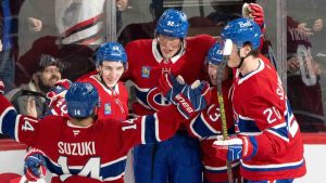 Montreal Canadiens' Patrik Laine (92) celebrates his first goal of the season with teammates Nick Suzuki (14), Lane Hutson (48), Cole Caufield (13) and Juraj Slafkovsky (20) during second period NHL hockey action against the New York Islanders in Montreal on Tuesday, Dec. 3, 2024. (Christinne Muschi/CP)