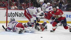 Florida Panthers centre Jesper Boqvist (70) goes for the puck before scoring a goal against New York Rangers goaltender Igor Shesterkin (31) during the second period of an NHL hockey game Monday, Dec. 30, 2024, in Sunrise, Fla. (Lynne Sladky/AP)