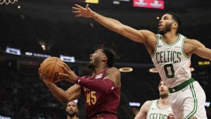 Cleveland Cavaliers guard Donovan Mitchell (45) goes to the basket in front of Boston Celtics forward Jayson Tatum (0) in the first half of an NBA basketball game, Sunday, Dec. 1, 2024, in Cleveland. (Sue Ogrocki/AP)