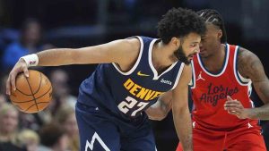 Denver Nuggets guard Jamal Murray, front, looks to drive to the rim as Los Angeles Clippers guard Bones Hyland defends in the second half of an NBA basketball game Friday, Dec. 13, 2024, in Denver. (David Zalubowski/AP)