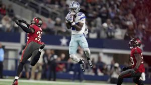 Dallas Cowboys wide receiver CeeDee Lamb (88) catches a pass between Tampa Bay Buccaneers cornerback Jamel Dean (35) and Christian Izien (29) in the first half of an NFL football game in Arlington, Texas, Sunday, Dec. 22, 2024. (Julio Cortez/AP)