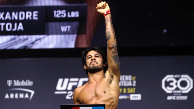 Alexandre-Pantoja-poses-on-the-scale-during-a-ceremonial-UFC-weigh-in