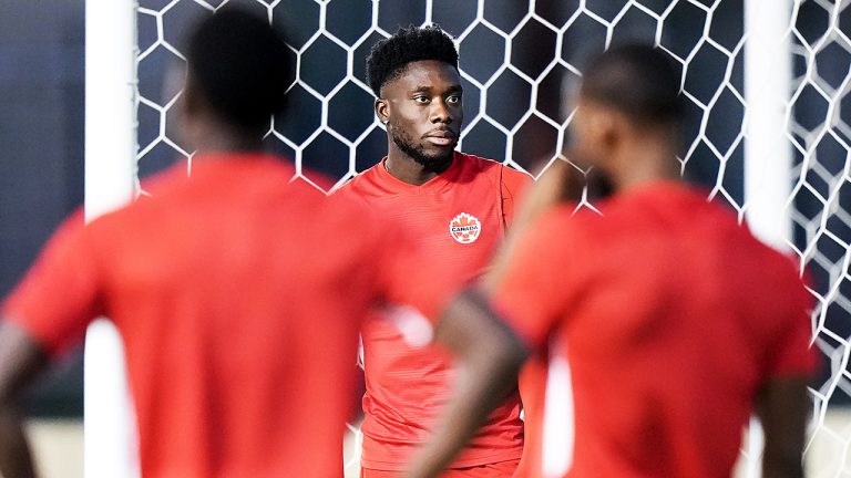 Canada's Alphonso Davies looks on with teammates during a training session for the national team ahead of the World Cup in Qatar. (Nathan Denette/CP)