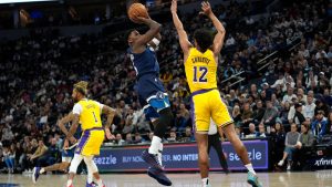 Minnesota Timberwolves guard Anthony Edwards (5) shoots over Los Angeles Lakers guard Max Christie (12) during the first half of an NBA basketball game. (Abbie Parr/AP)