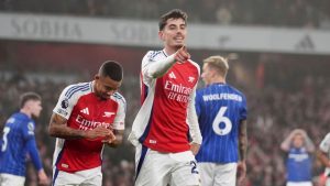 Arsenal's Kai Havertz, center, celebrates after scoring the opening goal during the English Premier League soccer match between Arsenal and Ipswich at the Emirates Stadium in London, England, Friday, Dec. 27, 2024. (John Walton/PA via AP)