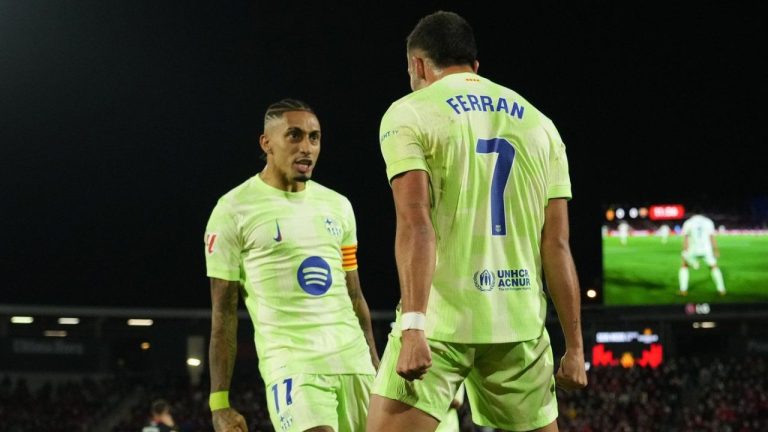 Barcelona's Ferran Torres, right, celebrates with Raphinha after scoring the opening goal during a Spanish La Liga soccer match between Mallorca and Barcelona at the Son Moix stadium in Palma de Mallorca, Spain, Tuesday, Dec. 3, 2024. (Jose Breton/AP)
