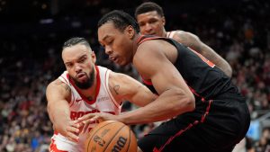 Houston Rockets forward Dillon Brooks (9) and Toronto Raptors forward Scottie Barnes (4) vie for control of the ball during second half NBA basketball action in Toronto, Sunday, Dec. 22, 2024. (Frank Gunn/CP)