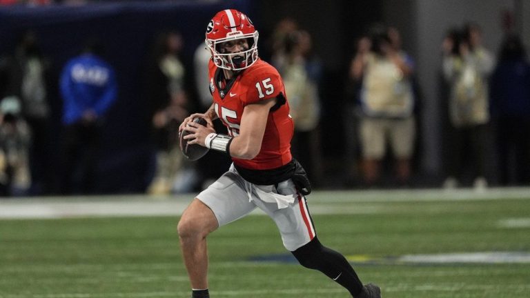 Georgia quarterback Carson Beck (15) runs out of the pocket against Texas during the first half of the Southeastern Conference championship NCAA college football game, Saturday, Dec. 7, 2024, in Atlanta. (John Bazemore/AP)
