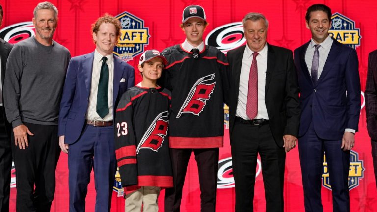 Bradly Nadeau poses with Carolina Hurricanes officials after being picked by the team during the first round of the NHL hockey draft Wednesday, June 28, 2023, in Nashville, Tenn. (George Walker IV/AP)