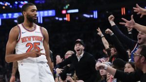 New York Knicks' Mikal Bridges, left, and fans react after Bridges hit a three point basket during the second half of an NBA basketball game, Wednesday, Dec. 25, 2024, in New York. The Knicks defeated the Spurs 117-114. (Seth Wenig/AP)