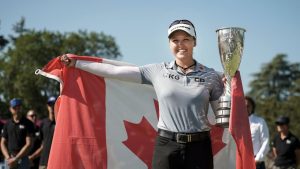 Brooke Henderson, of Canada, celebrates with her trophy after winning the Evian Championship women's golf tournament in Evian, eastern France, Sunday, July 24, 2022. (Laurent Cipriani/AP)